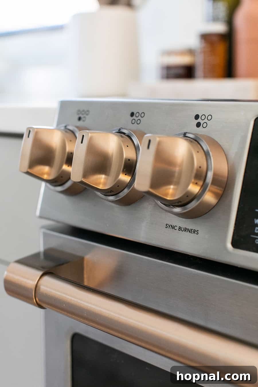 Tiny Kitchen Big Impact 15 Brush bronze handles on stainless steel range highlighting customization