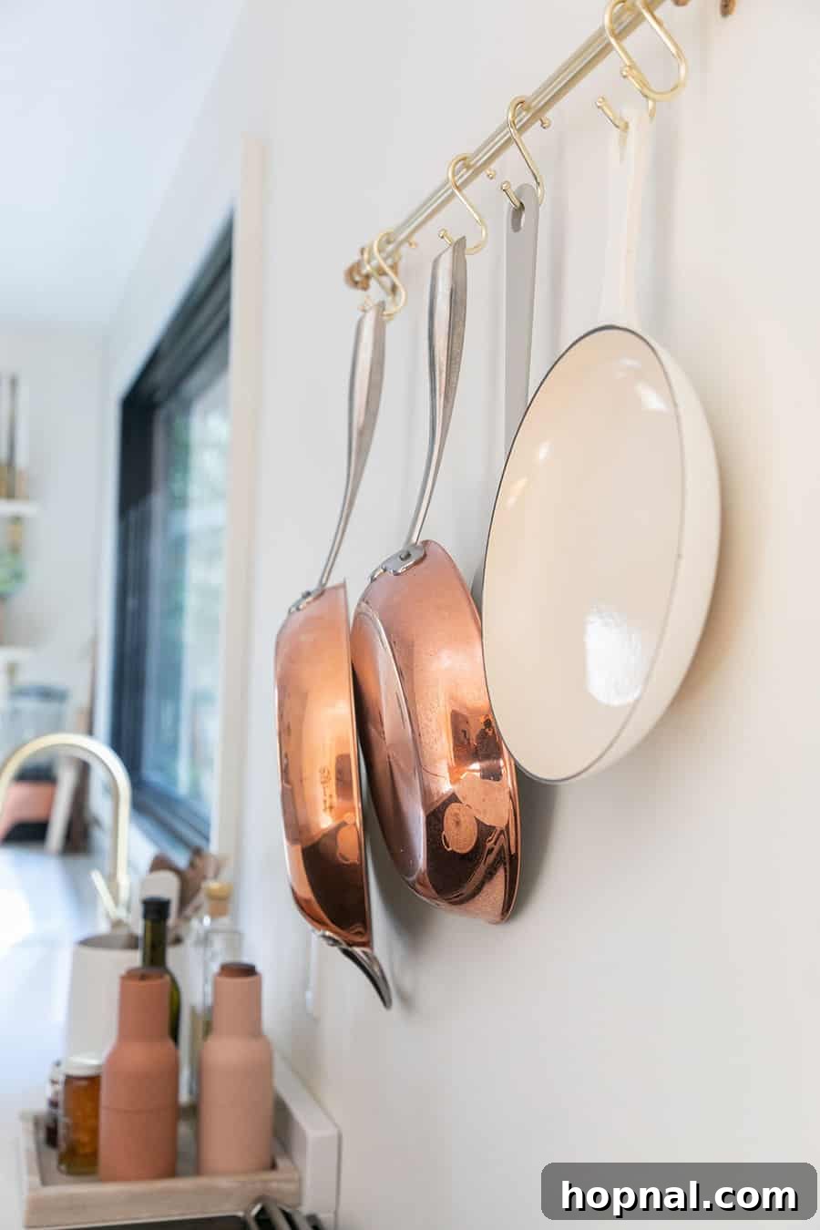 Tiny Kitchen Big Impact 16 Williams Sonoma copper pots displayed in a kitchen