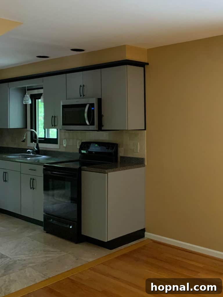 Tiny Kitchen Big Impact 3 Before image of kitchen with yellow walls and dark appliances