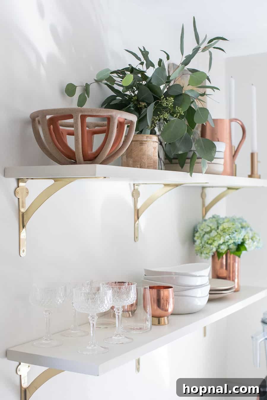 Tiny Kitchen Big Impact 23 white open shelving with bowls, flowers, glasses and plates in a renovated kitchen