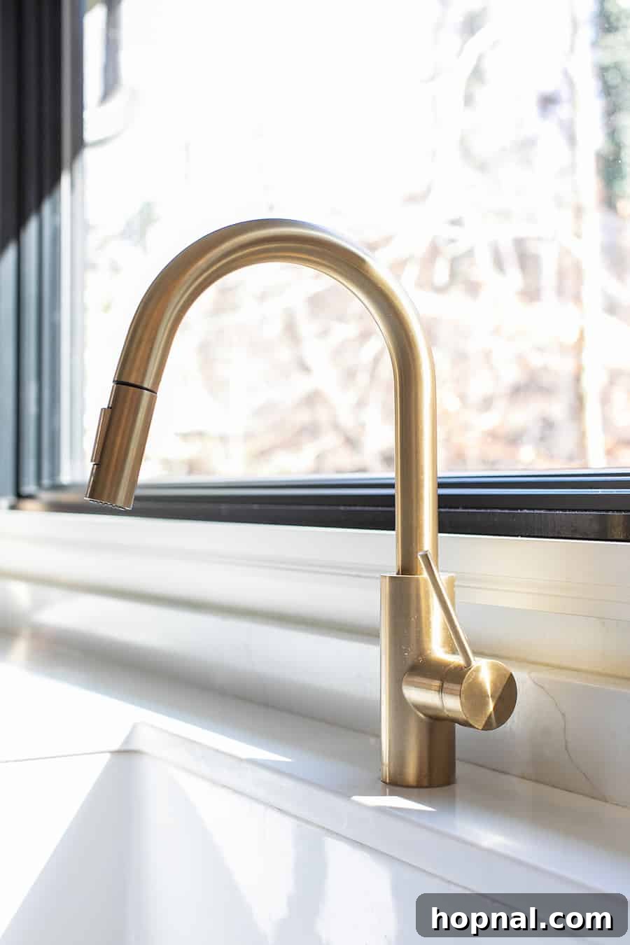 Tiny Kitchen Big Impact 10 Brass kitchen faucet over a large window