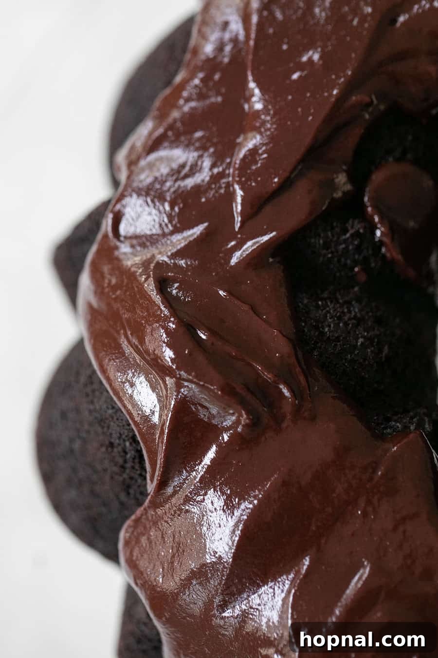 Close-up of a bowl filled with luscious, smooth chocolate ganache, ready for use as a dipping sauce or topping.