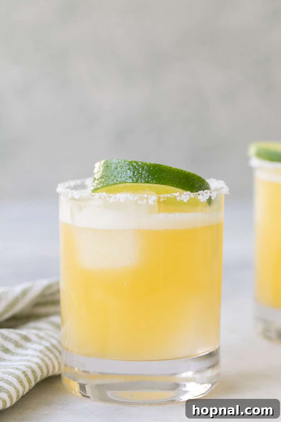 Skinny Margarita in a glass with a lime wedge, a low-calorie and guilt-free tequila option.