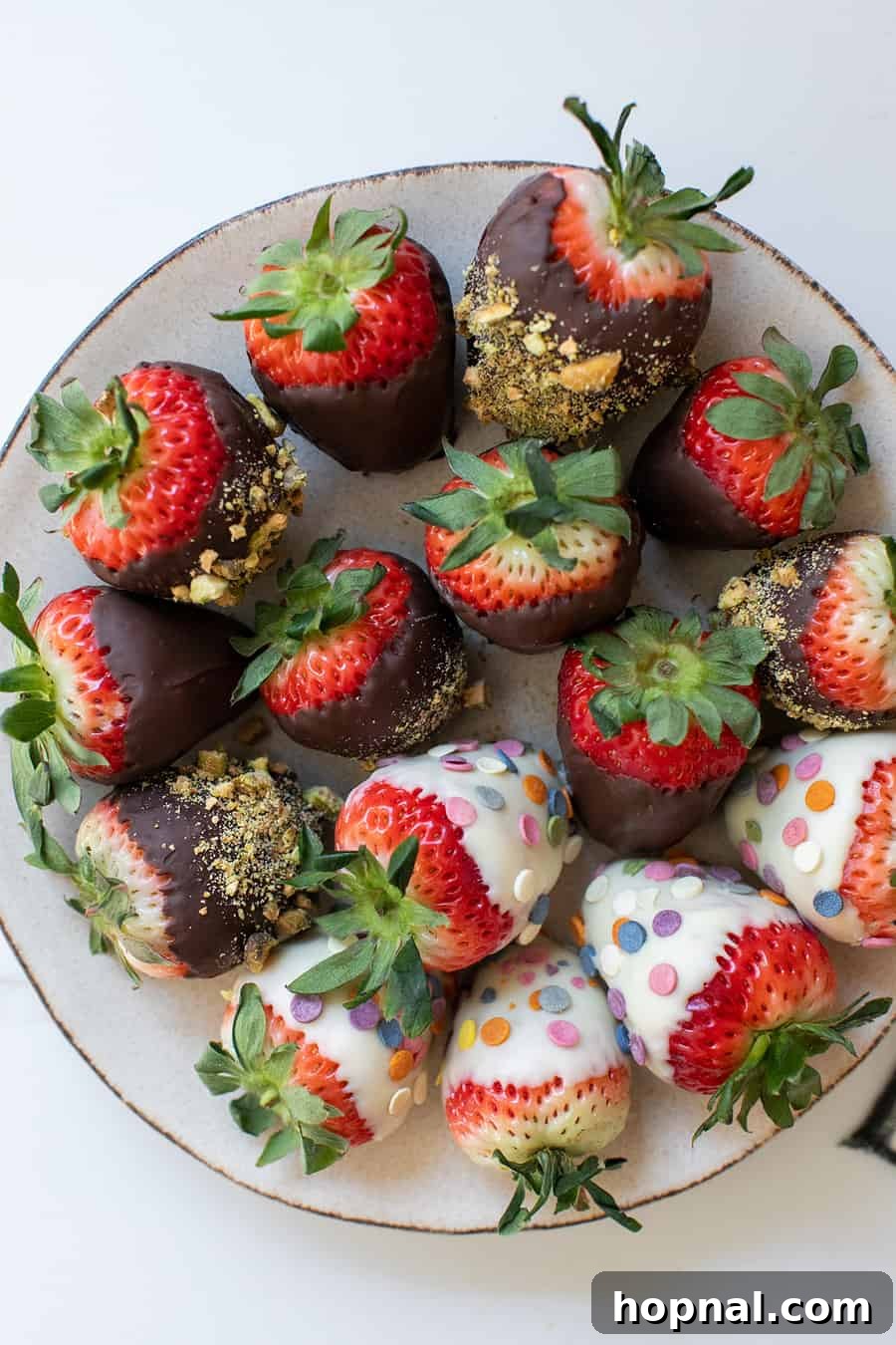 Chocolate covered strawberries with sprinkles and crushed nuts