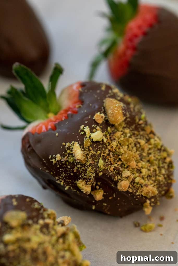 crushed nuts on a chocolate covered strawberry 