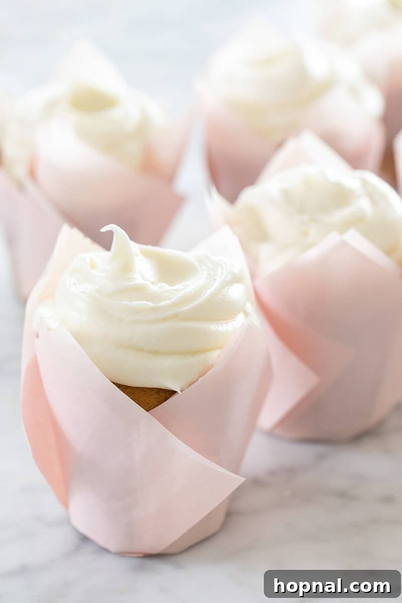 Your Ultimate Easter Recipe Collection 18 Moist old-fashioned carrot cake cupcakes with creamy cream cheese frosting, a classic Easter dessert.