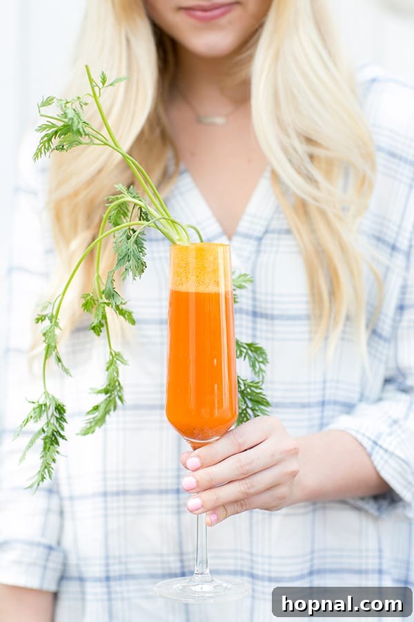 Your Ultimate Easter Recipe Collection 24 Vibrant carrot mimosa with blood orange, a festive and healthy Easter cocktail.