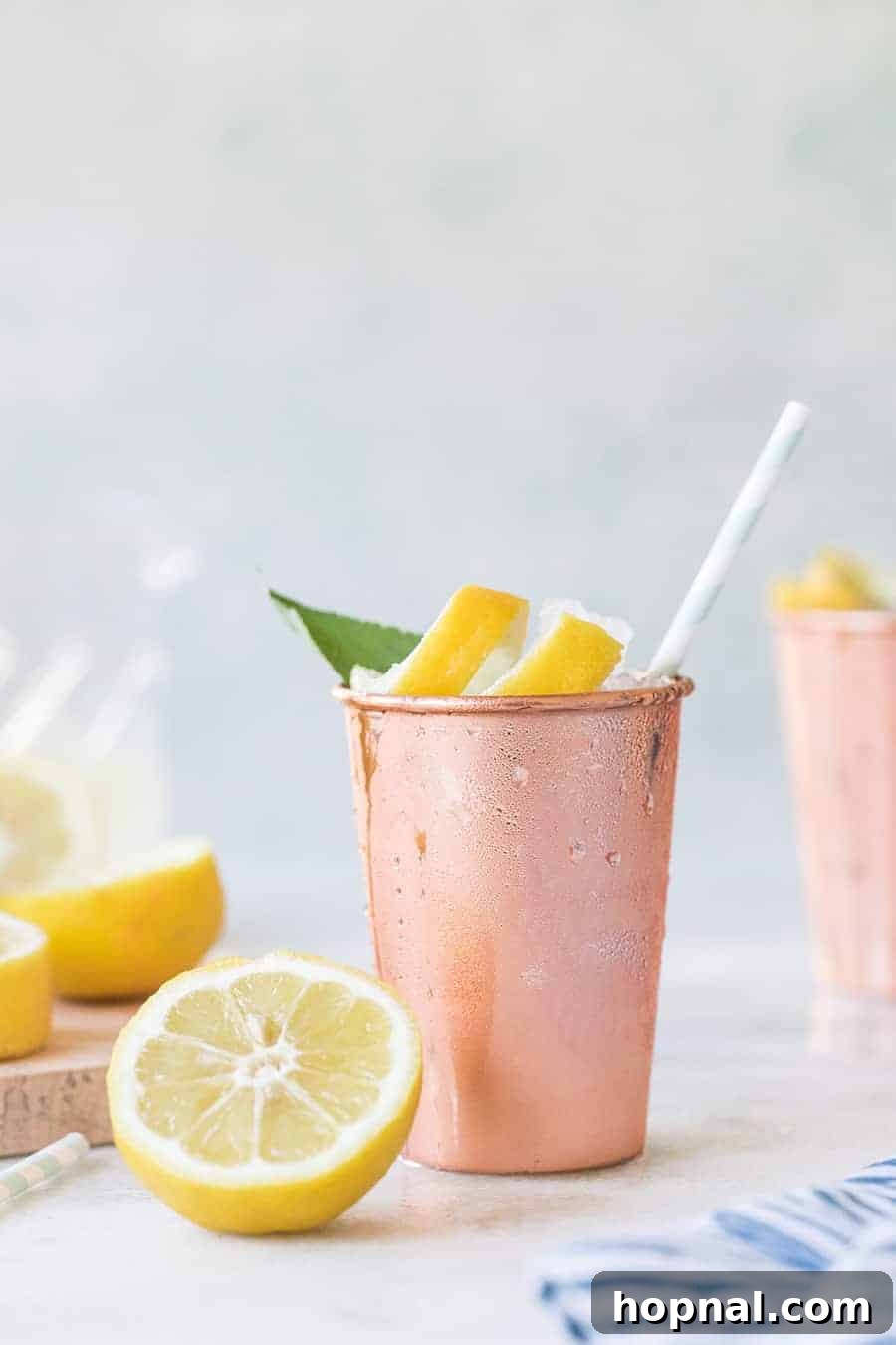 Your Ultimate Easter Recipe Collection 29 Refreshing lemon and sage Moscow mule cocktail in a copper mug, perfect for spring brunch.