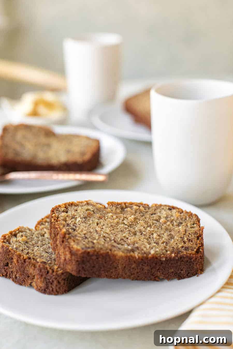 Your Ultimate Easter Recipe Collection 9 Moist and delicious banana bread loaf on a white plate, perfect for Easter breakfast.