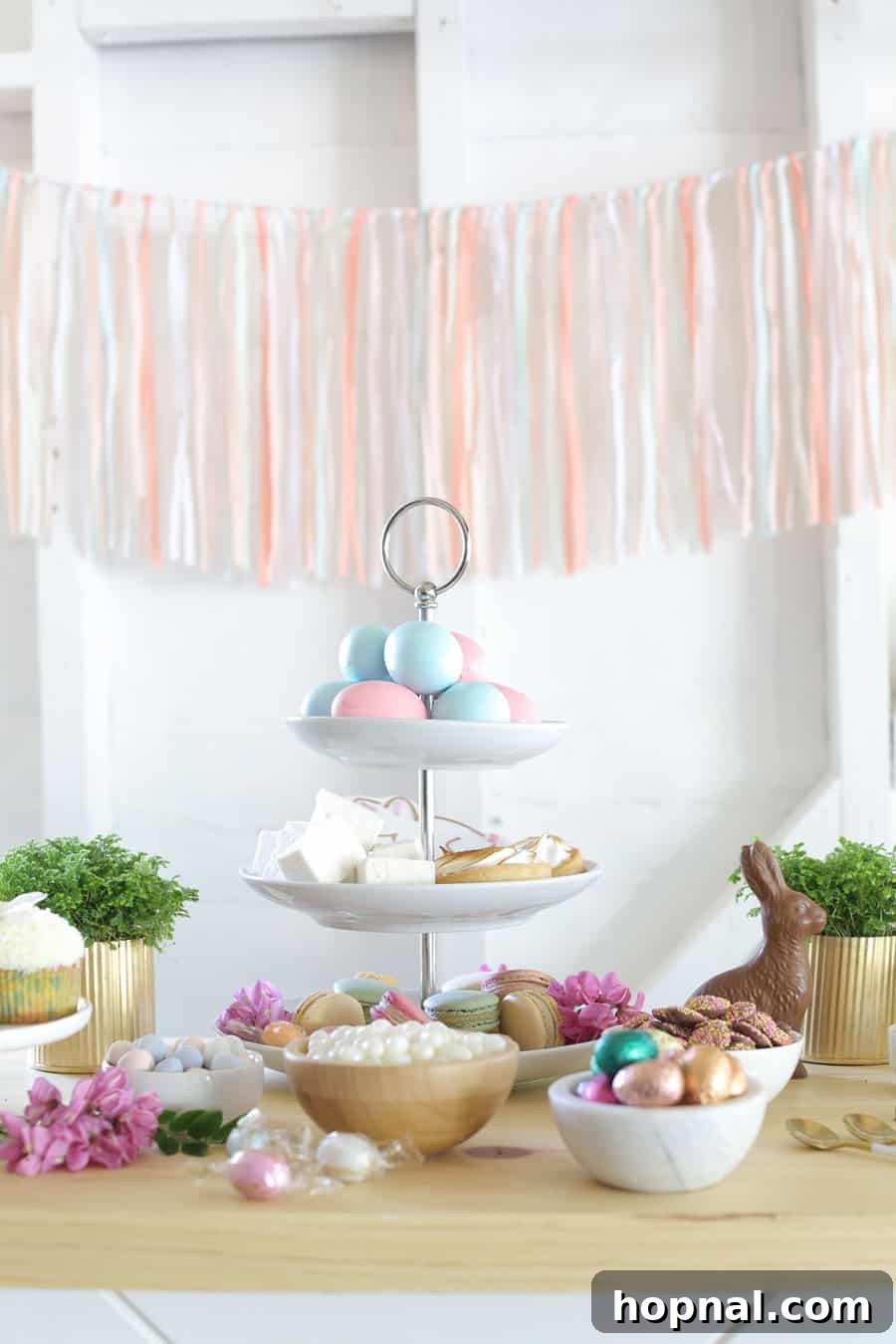 A beautifully arranged table showcasing an assortment of Easter dessert ideas, featuring chocolates, decorated eggs, and fluffy marshmallows, perfect for a festive celebration.