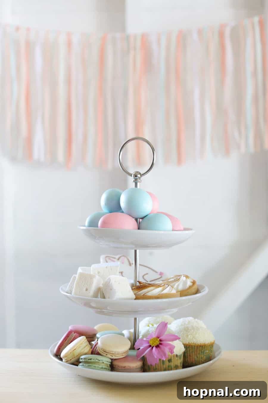 An impressive dessert tower adorned with a variety of Easter treats, perfect for a grand holiday display.