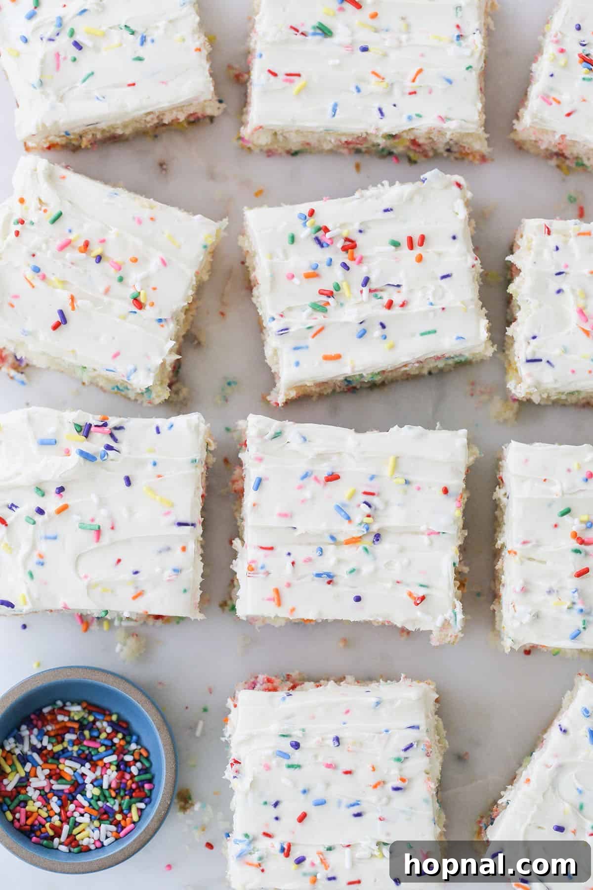 A generous slice of homemade funfetti cake, adorned with colorful sprinkles, showcasing its fluffy texture.