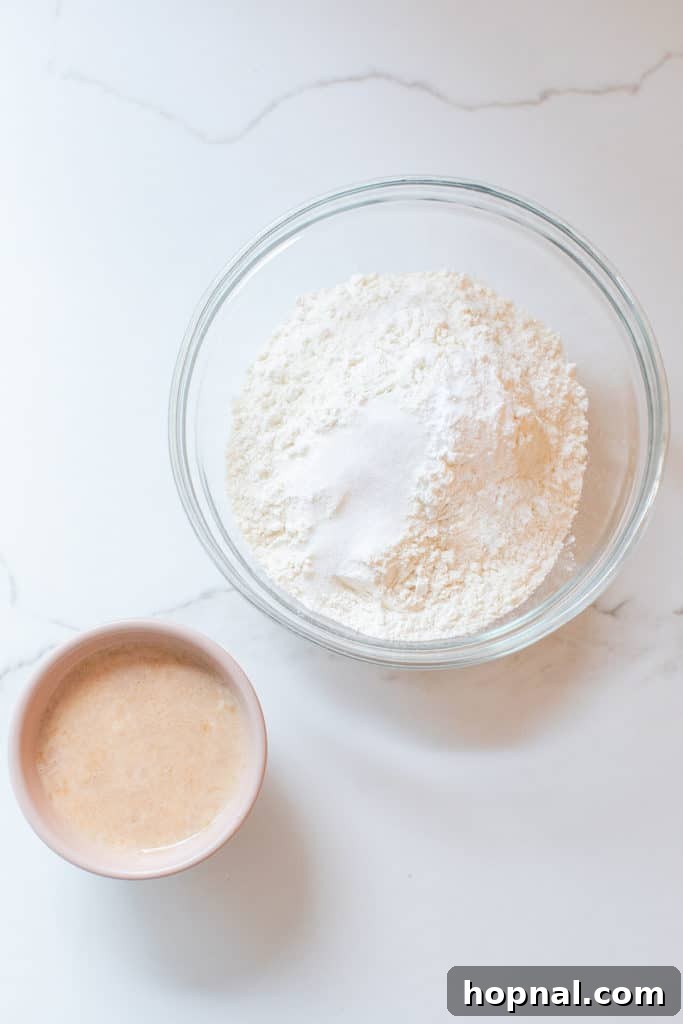Timeless Pound Cake Perfection 4 Dry ingredients including flour, baking powder, and salt in a bowl, alongside a small bowl of milk infused with vanilla extract, ready for mixing.