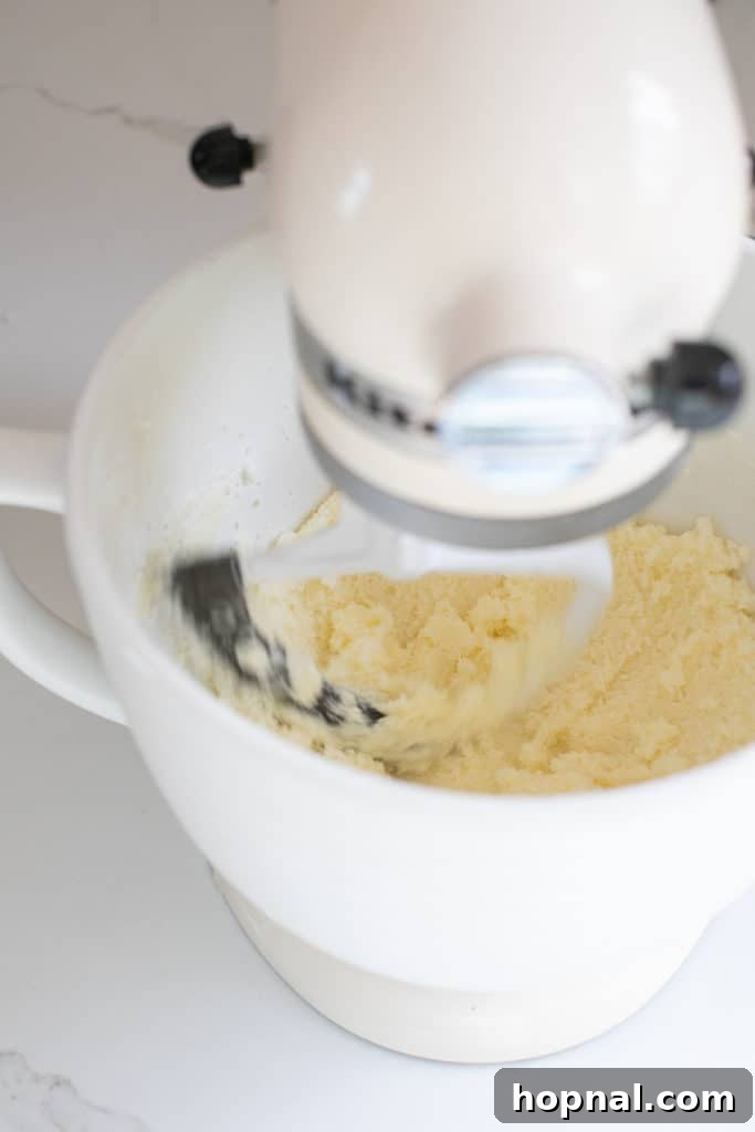 Timeless Pound Cake Perfection 5 Butter and granulated sugar being creamed together in a stand mixer, demonstrating the initial stage of preparing pound cake batter.