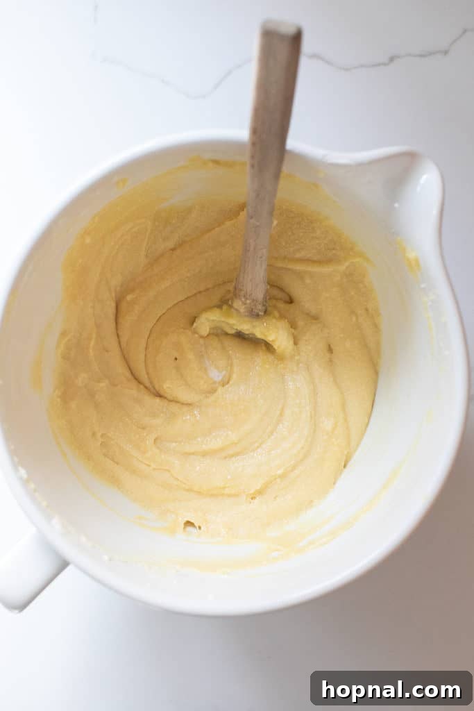 Timeless Pound Cake Perfection 6 Smooth, well-combined pound cake batter in a large mixing bowl, showcasing its creamy texture before being poured into the pan.