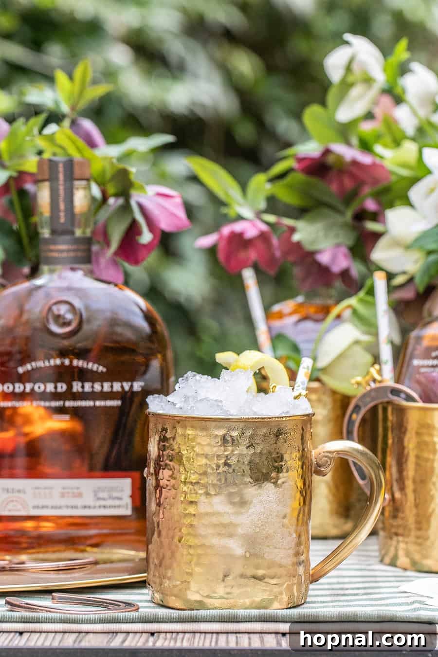 Hammered gold mug holding a refreshing Woodford Spire cocktail, perfect for a Derby party.
