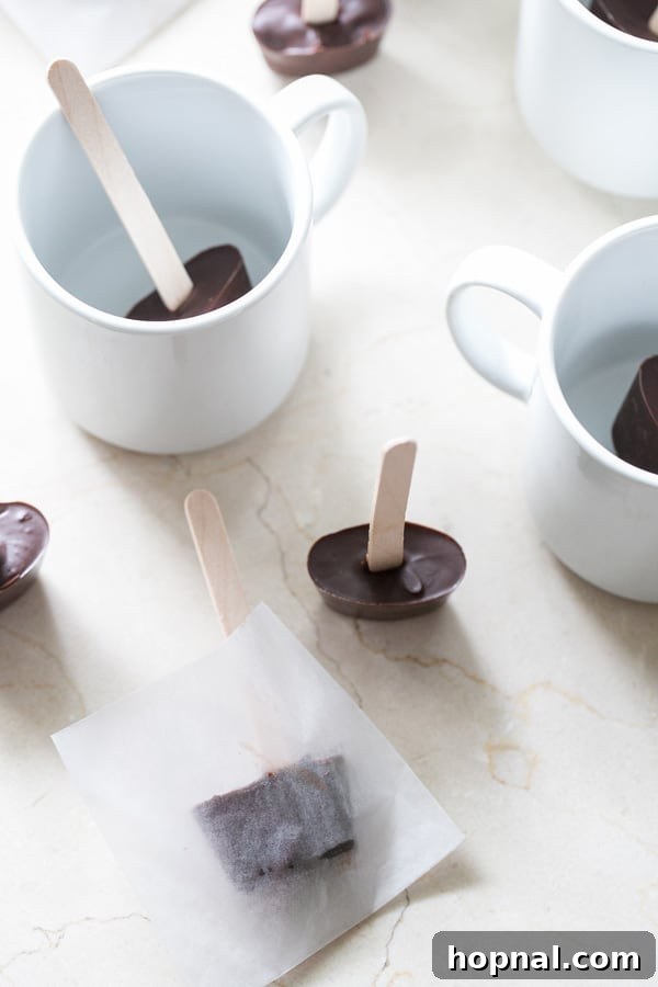 Finished hot chocolate sticks, arranged elegantly with mugs.