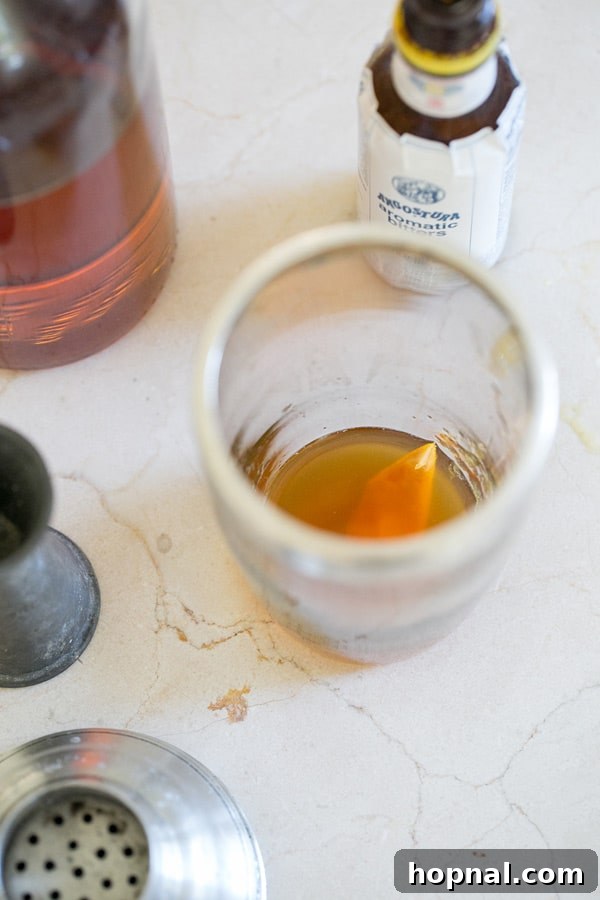 Top-down shot of orange peel and ice in an Old Fashioned cocktail