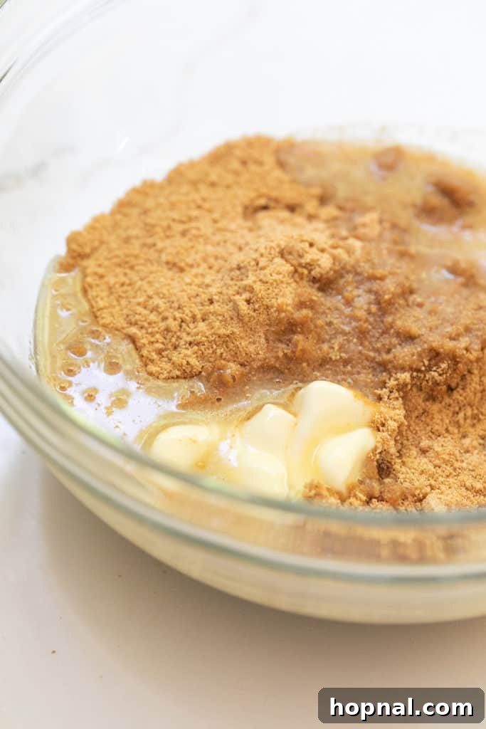 Irresistible Homemade Cheesecake 4 A bowl containing butter, sugar, and crushed Graham Crackers, ready to be mixed for the cheesecake crust.