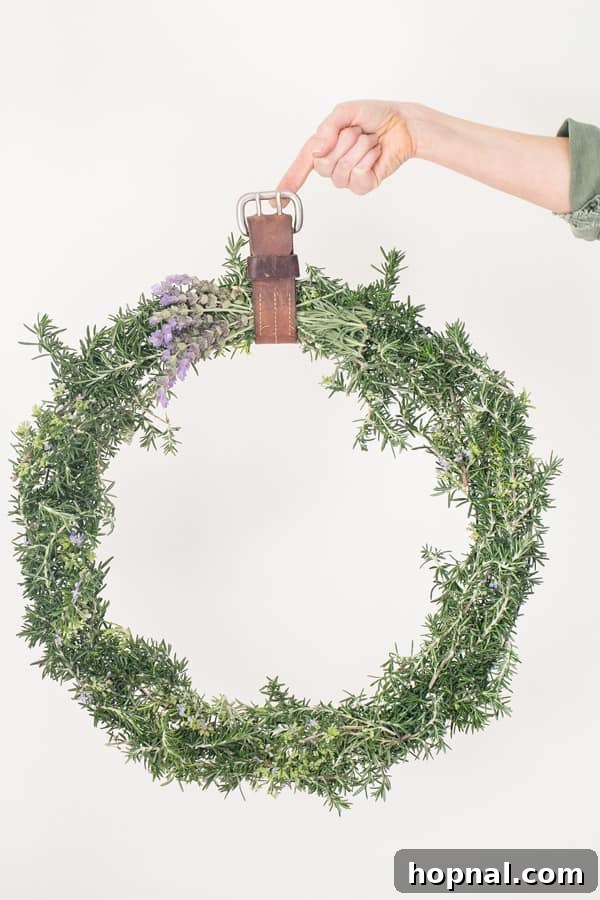 Stunning close-up shot of a finished rustic rosemary wreath, perfect for adding natural charm to any door. Features lush rosemary sprigs, a simple design, and a classic appeal.