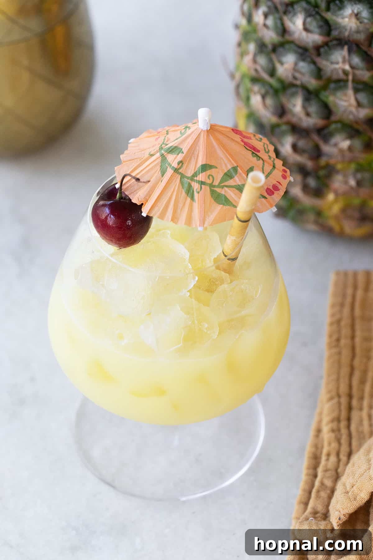 Classic Piña Colada recipe in a hurricane glass.