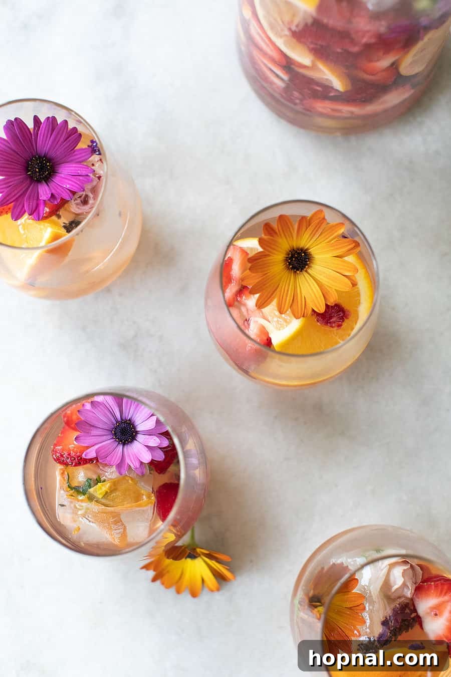 Summer Sangria recipe with fresh fruits and edible flowers.