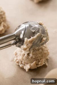 Ultimate Kitchen Sink Cookies 11 cookie scooper scooping kitchen sink cookie dough onto a baking sheet