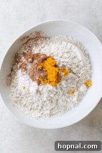 Dry ingredients: flour, orange zest, and spices mixed in a bowl.