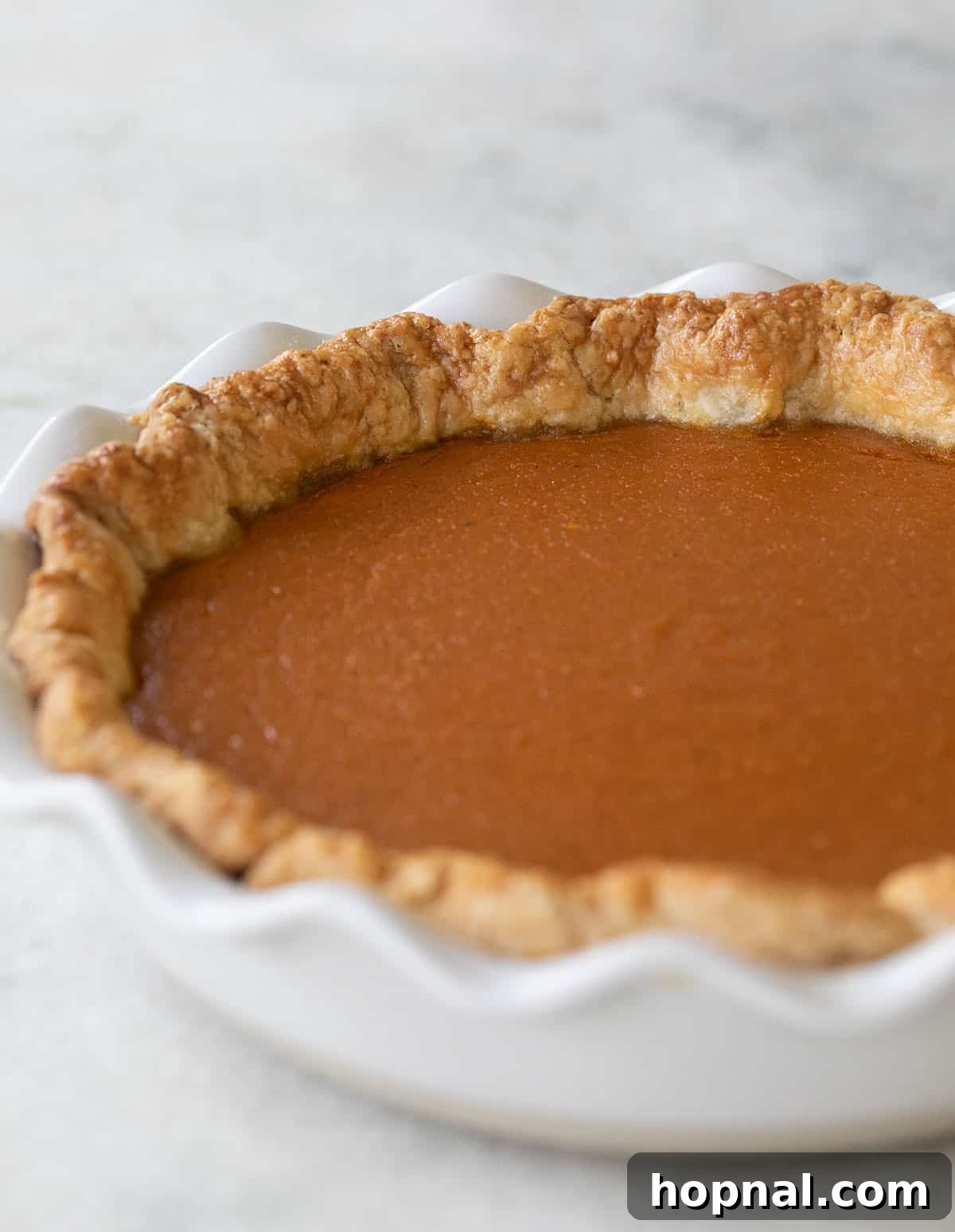Baked sweet potato pie in homemade pie crust.