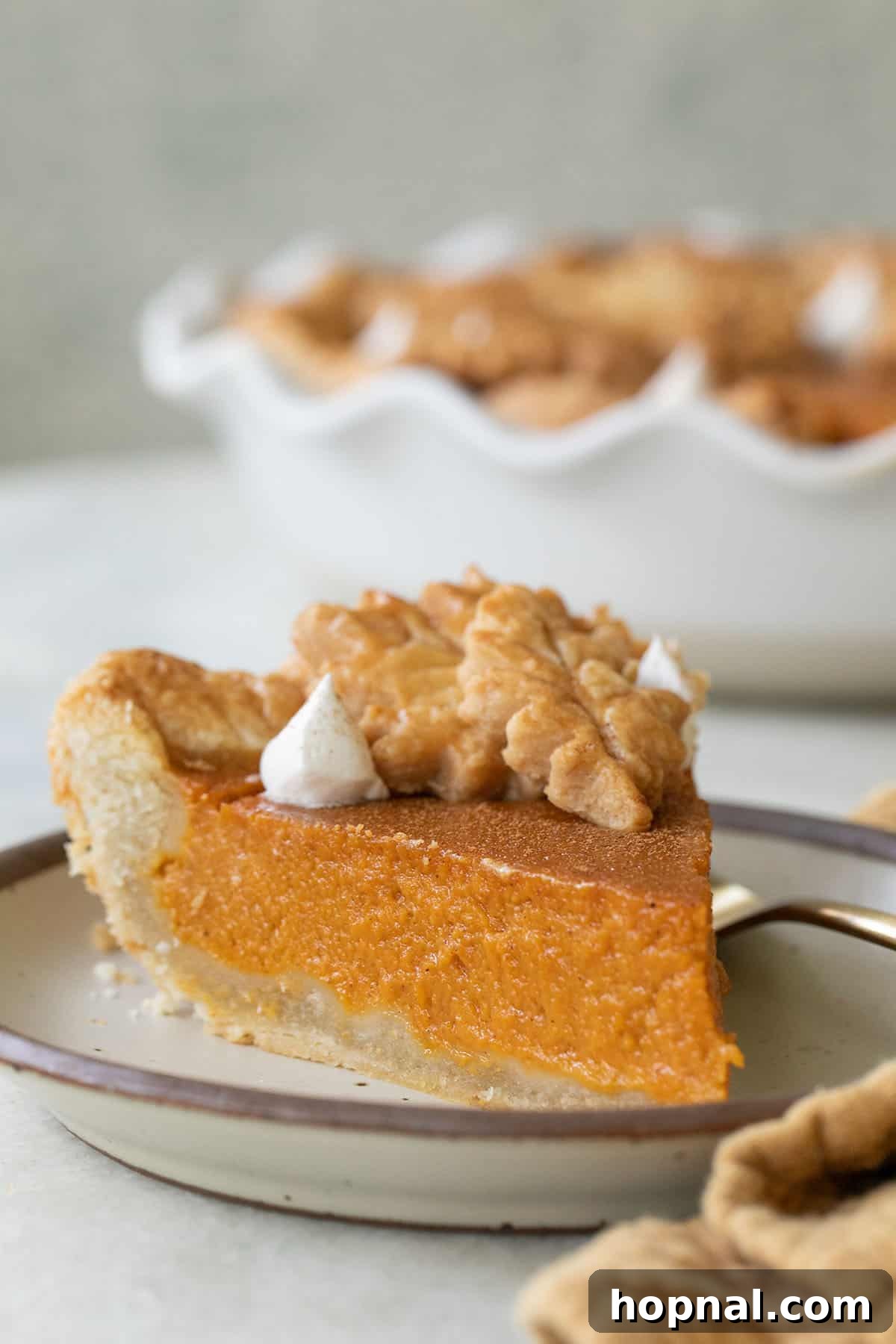 Slice of thick and creamy sweet potato pie homemade with buttery pie crust.