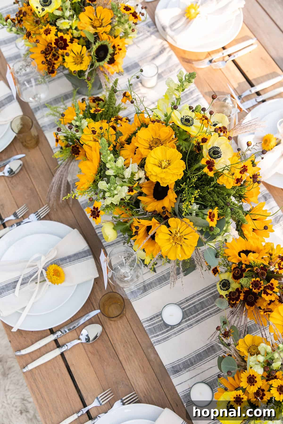 Beautiful fall table setting for an autumn harvest party with sunflowers