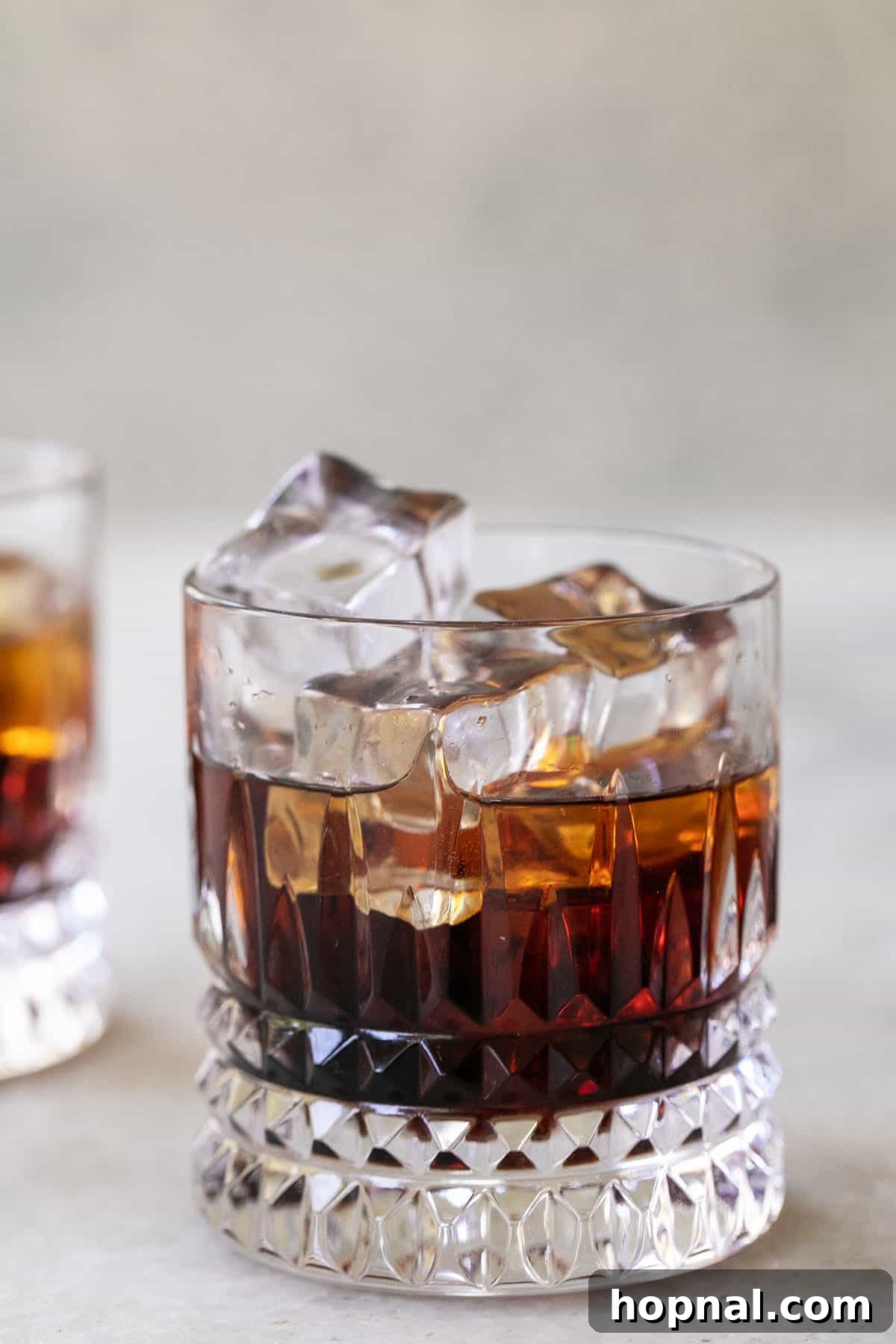 Cloud White Russian 4 Vodka and Kahlúa being poured into a glass filled with ice