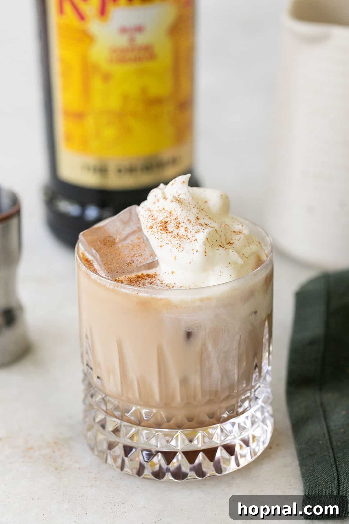 Cloud White Russian 7 Close-up shot of a White Russian cocktail with a cinnamon stick garnish