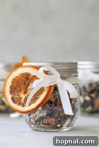 Beautifully packaged mulling spices with a dried orange slice, perfect for gifting.