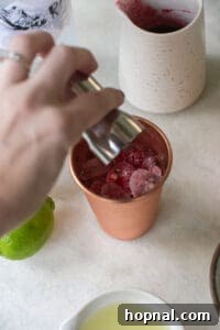 pouring vodka into a copper mug