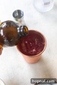 ginger beer pouring into a copper cup