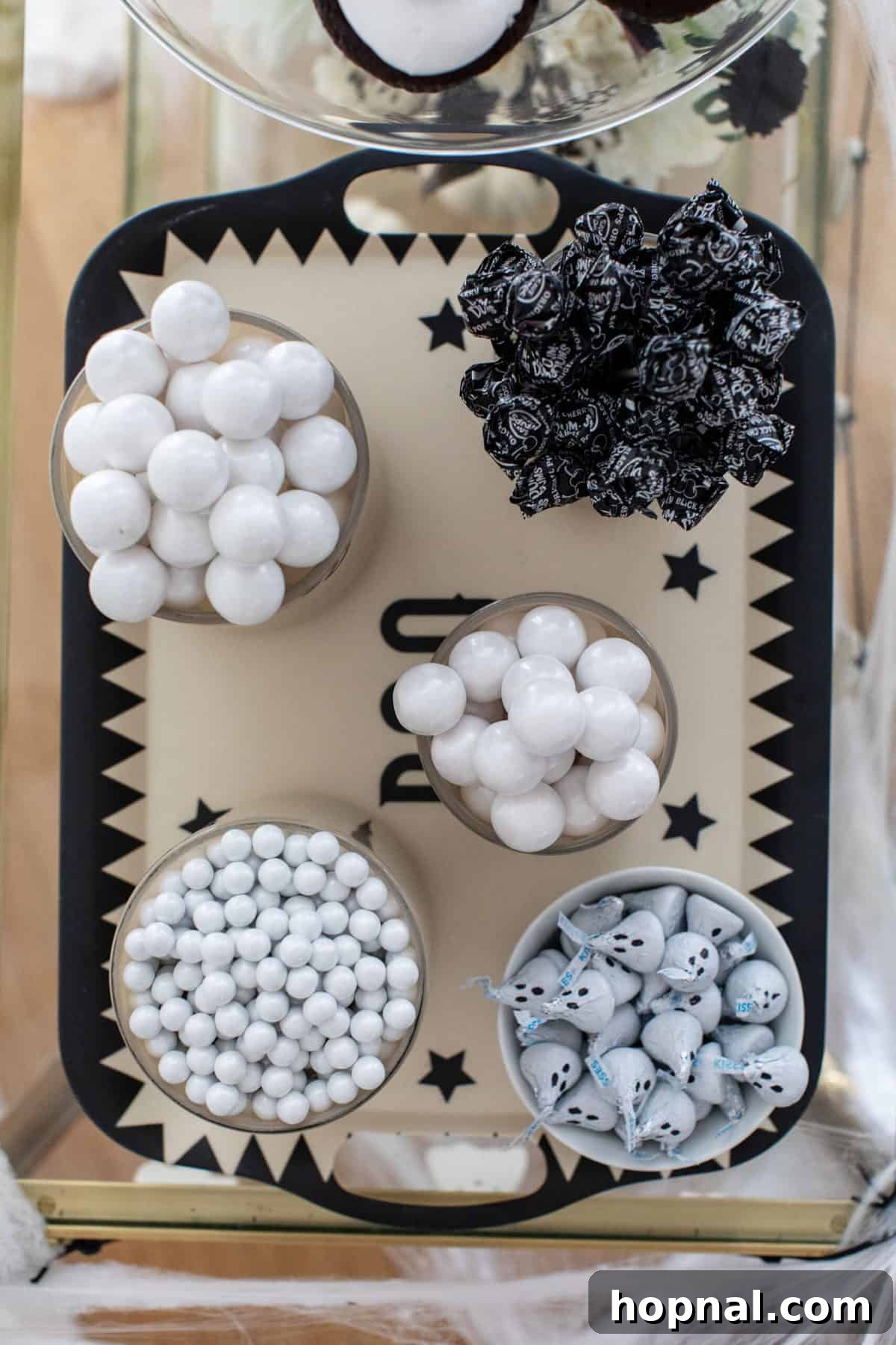 Variety of Halloween candies arranged on a decorative tray.