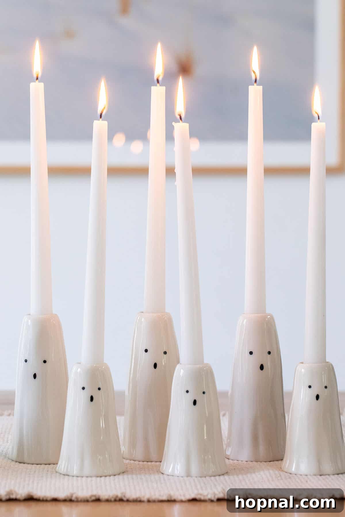 Decorative ghost candle holders providing ambient light.