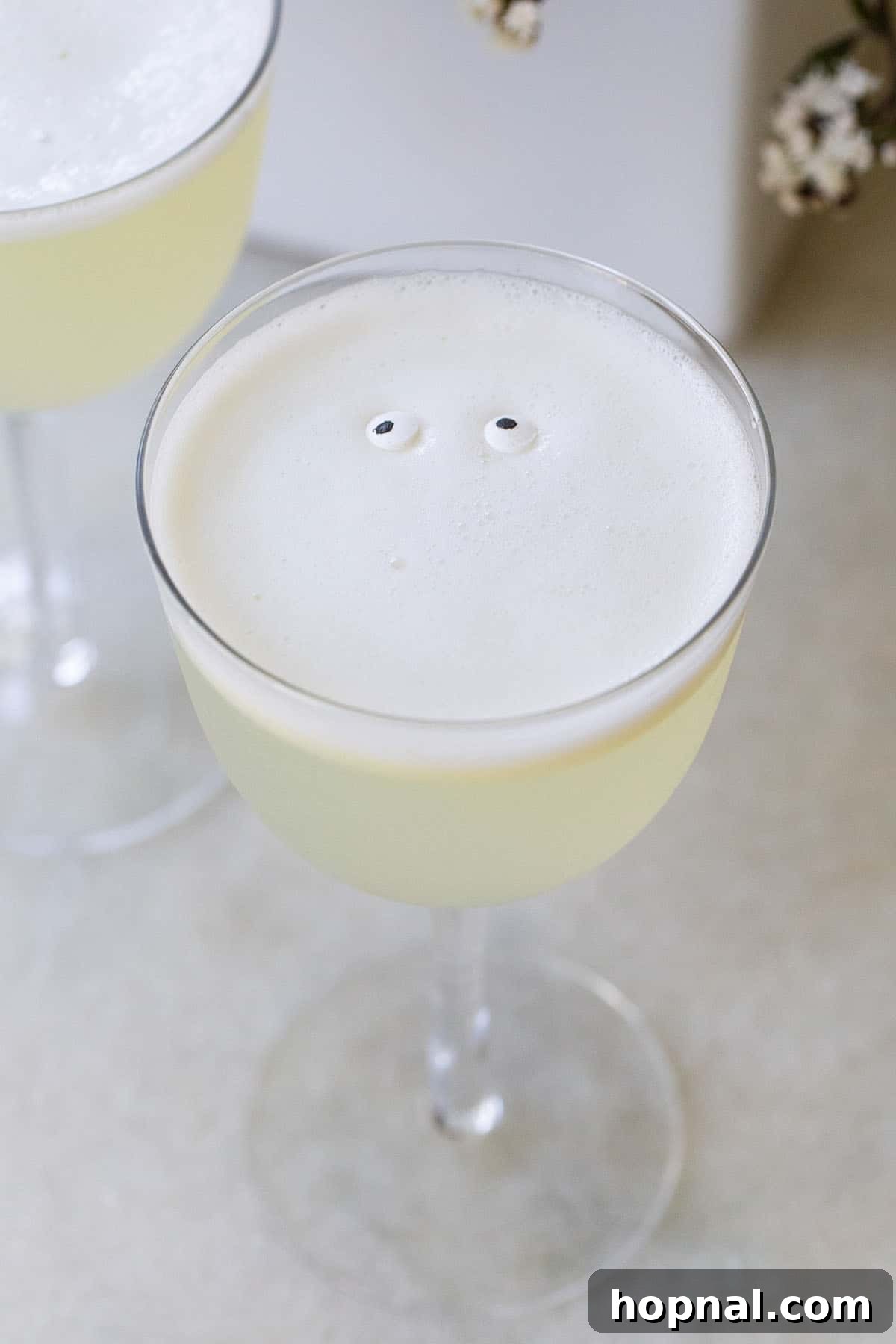 White Lady cocktail garnished with edible eye sprinkles for a spooky effect.