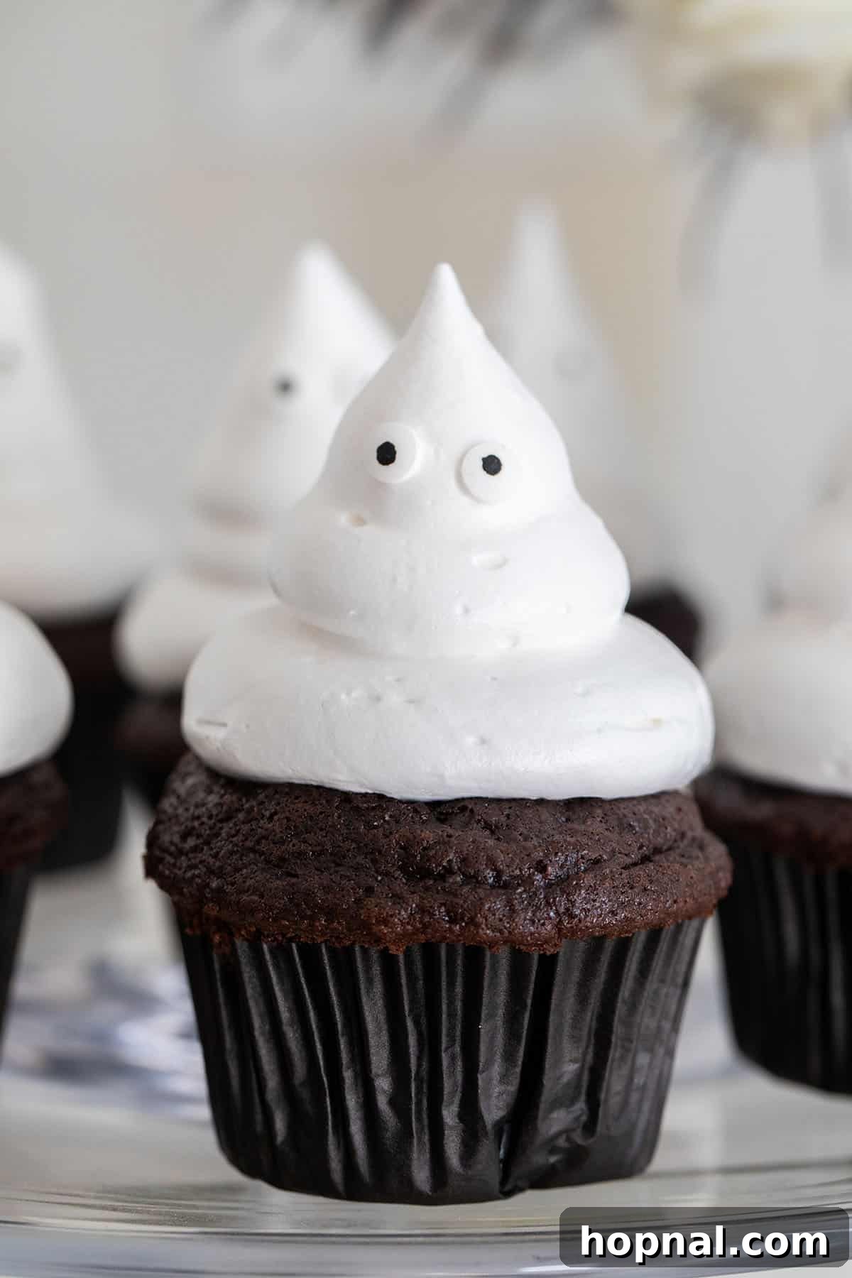 Ghost cupcakes topped with fluffy marshmallow fluff.