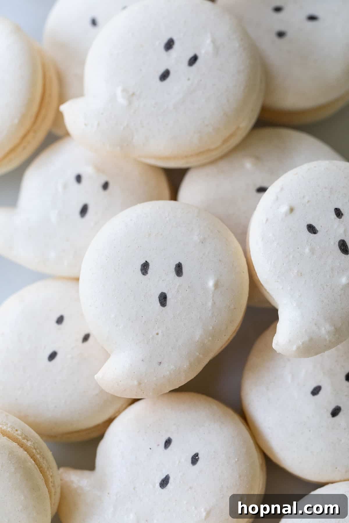 Delicate ghost macarons with subtle edible eyes.