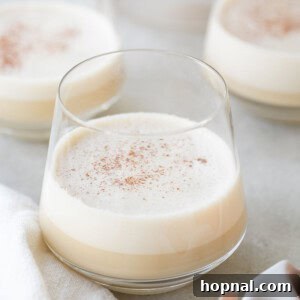 Delicious homemade spiked eggnog in a glass, ready for enjoyment.
