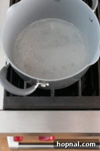 Sugar and water caramelizing in a saucepan.