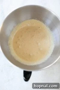 Whipped egg yolks, brown sugar, and vanilla extract in a mixing bowl.