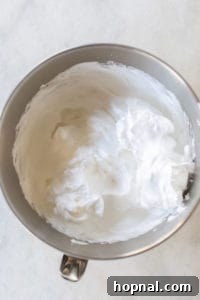 Stiffly whipped egg whites in a bowl.