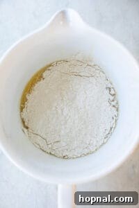 Festive Eggnog Cinnamon Buns 13 cinnamon roll dough forming in a bowl