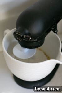 Festive Eggnog Cinnamon Buns 14 mixing cinnamon roll dough with an electric mixer