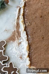 Festive Eggnog Cinnamon Buns 19 rolling cinnamon roll dough into a log