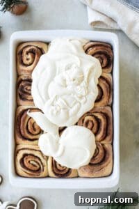 Festive Eggnog Cinnamon Buns 24 eggnog cinnamon roll icing spread over warm rolls