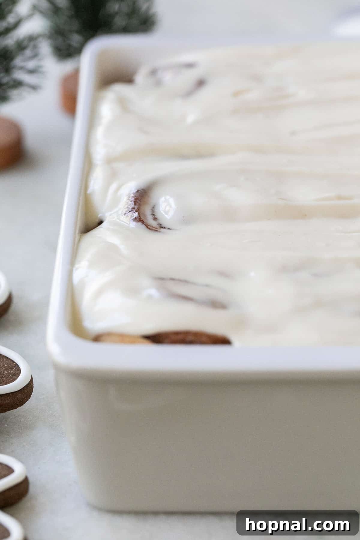 Festive Eggnog Cinnamon Buns 8 A pan full of fluffy, homemade eggnog cinnamon rolls, generously topped with a thick, smooth eggnog glaze.
